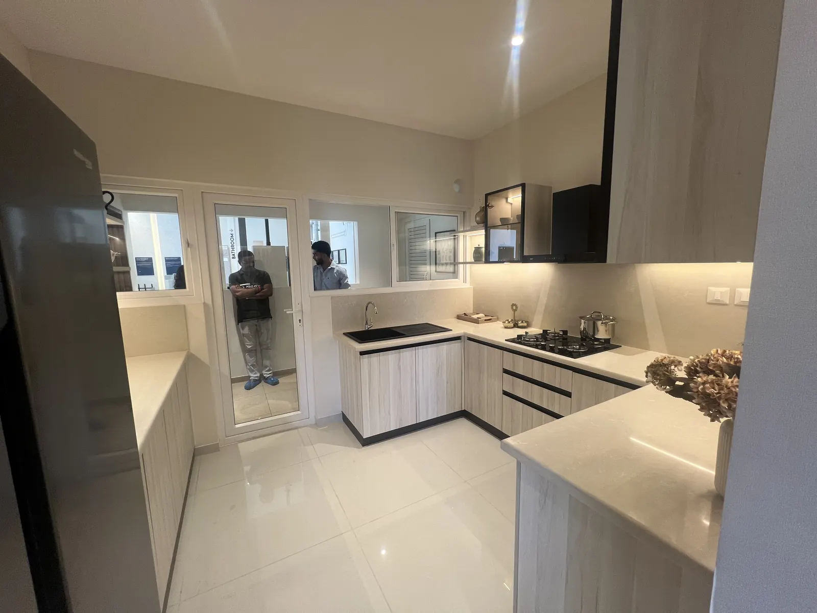 Featured Image of Godrej Vanantara 3 BHK (3T) Model Apartment U-shaped Modular Kitchen with light wood cabinets